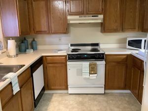 A cozy kitchen with wooden cabinets and standard appliances.