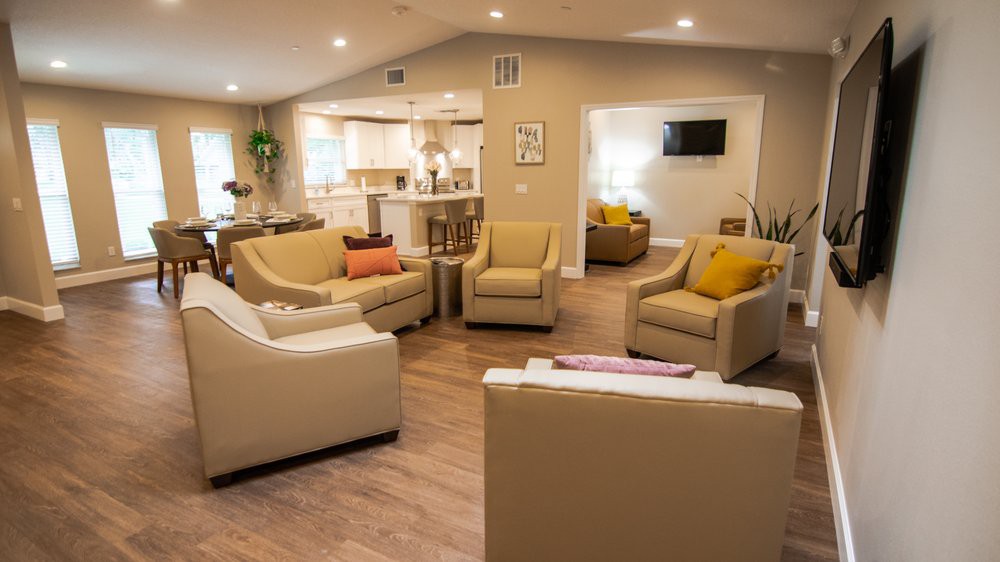 A cozy and modern living room with neutral-colored sofas arranged in an open floor plan.