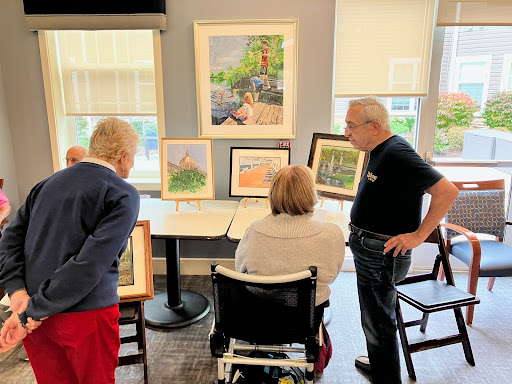 Community members engage in a discussion about the art on display during a local exhibition.