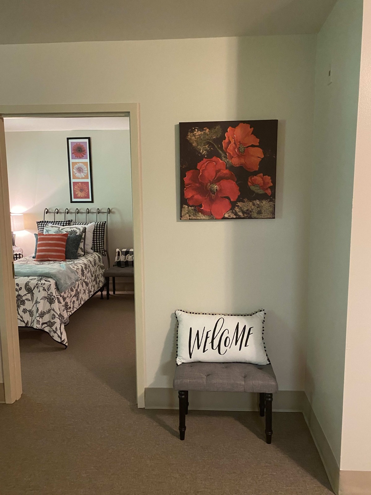 A cozy hallway leading to a bedroom with floral decor and welcoming accents.