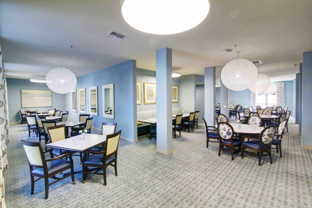 A modern dining area with elegantly arranged tables and contemporary lighting.