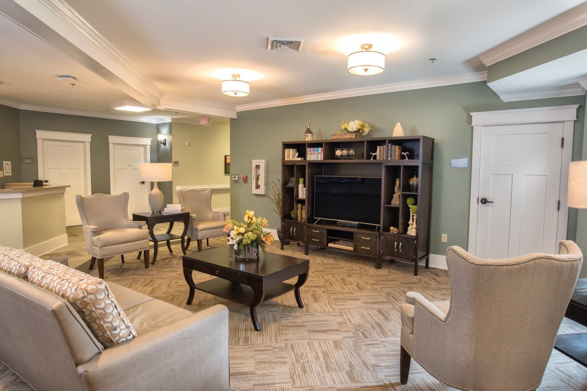 A cozy living room with elegant furniture and a large entertainment center.