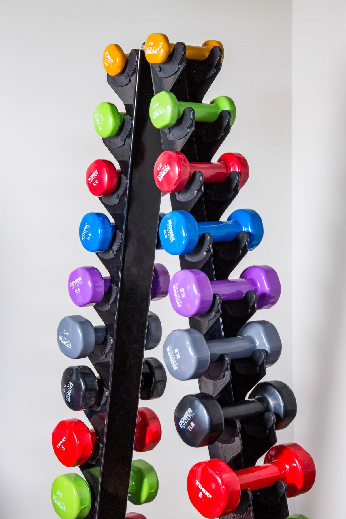 A rack of colorful dumbbells arranged for workout sessions.