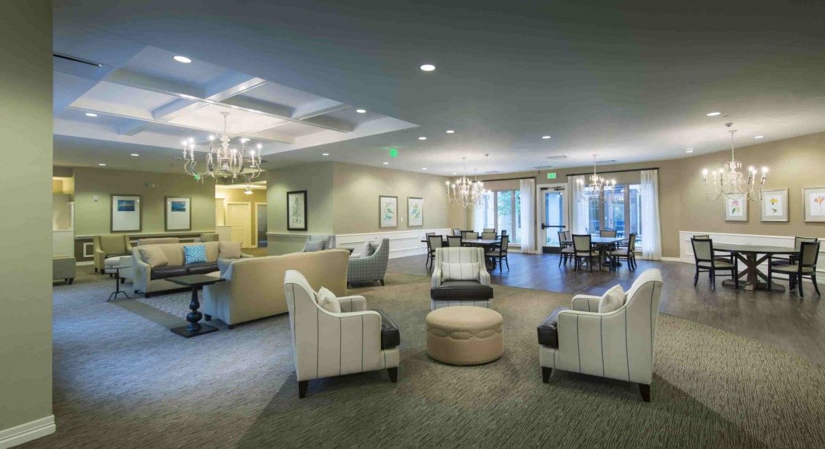 A modern lobby with comfortable seating and elegant chandeliers.