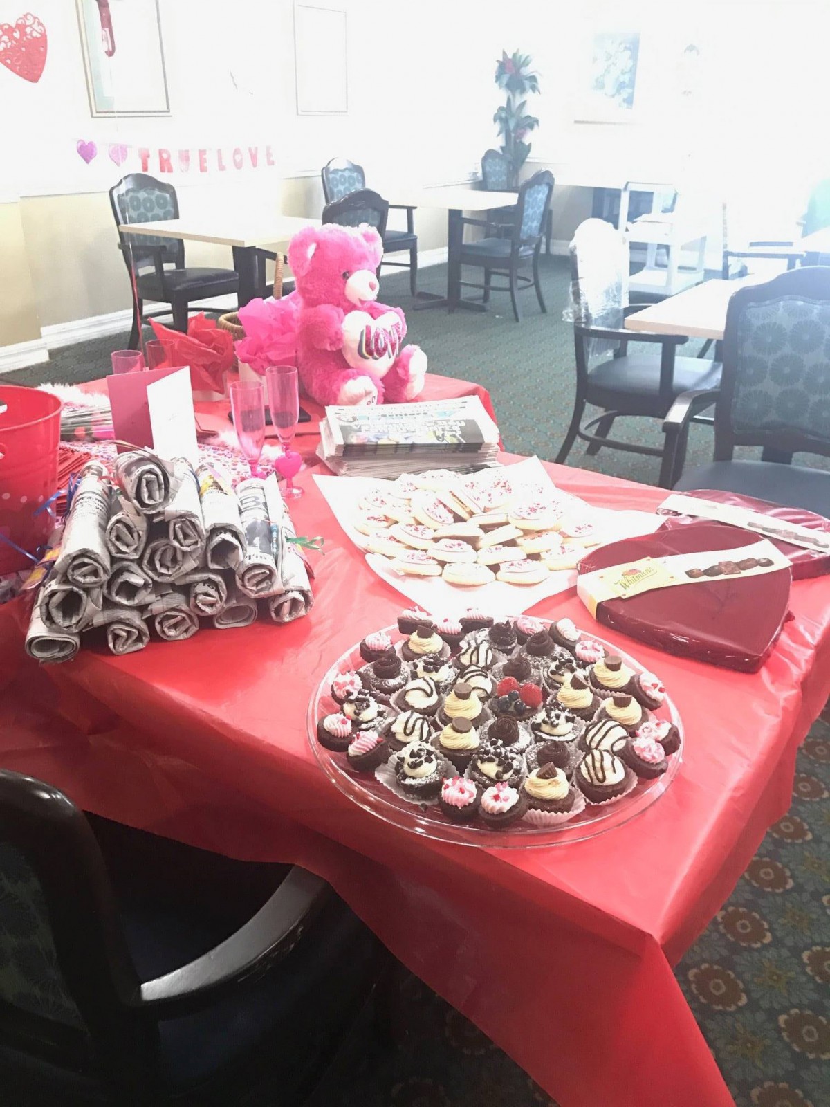 A festive table set up with Valentine's Day themed sweets and decorations.