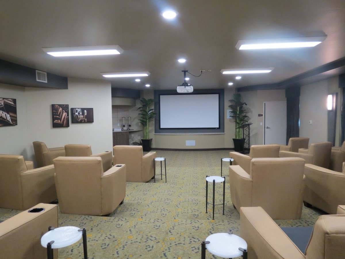 A cozy home theater with comfortable seating and a large screen for viewing.