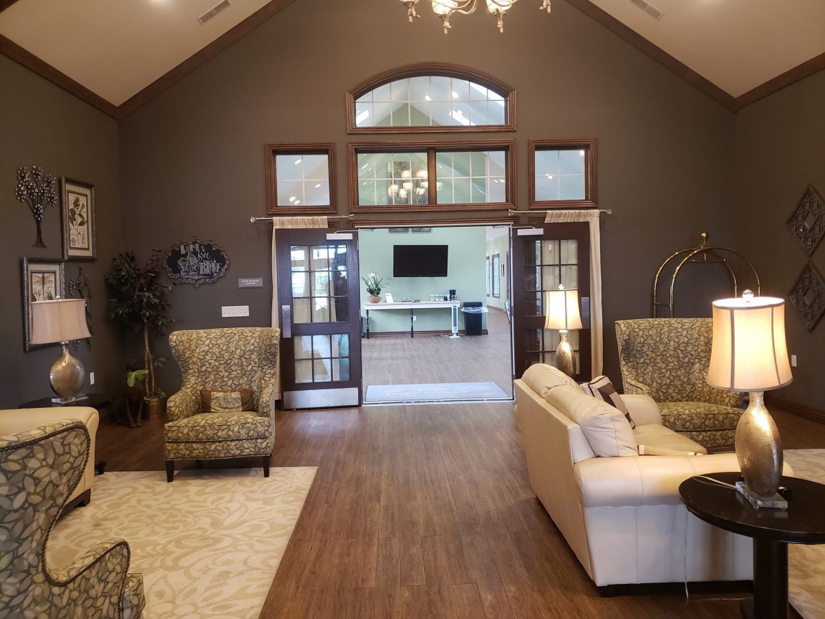 A cozy living room with elegant furnishings and a vaulted ceiling.