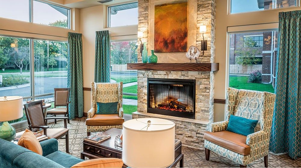 A cozy living room with a stone fireplace and elegant decor.