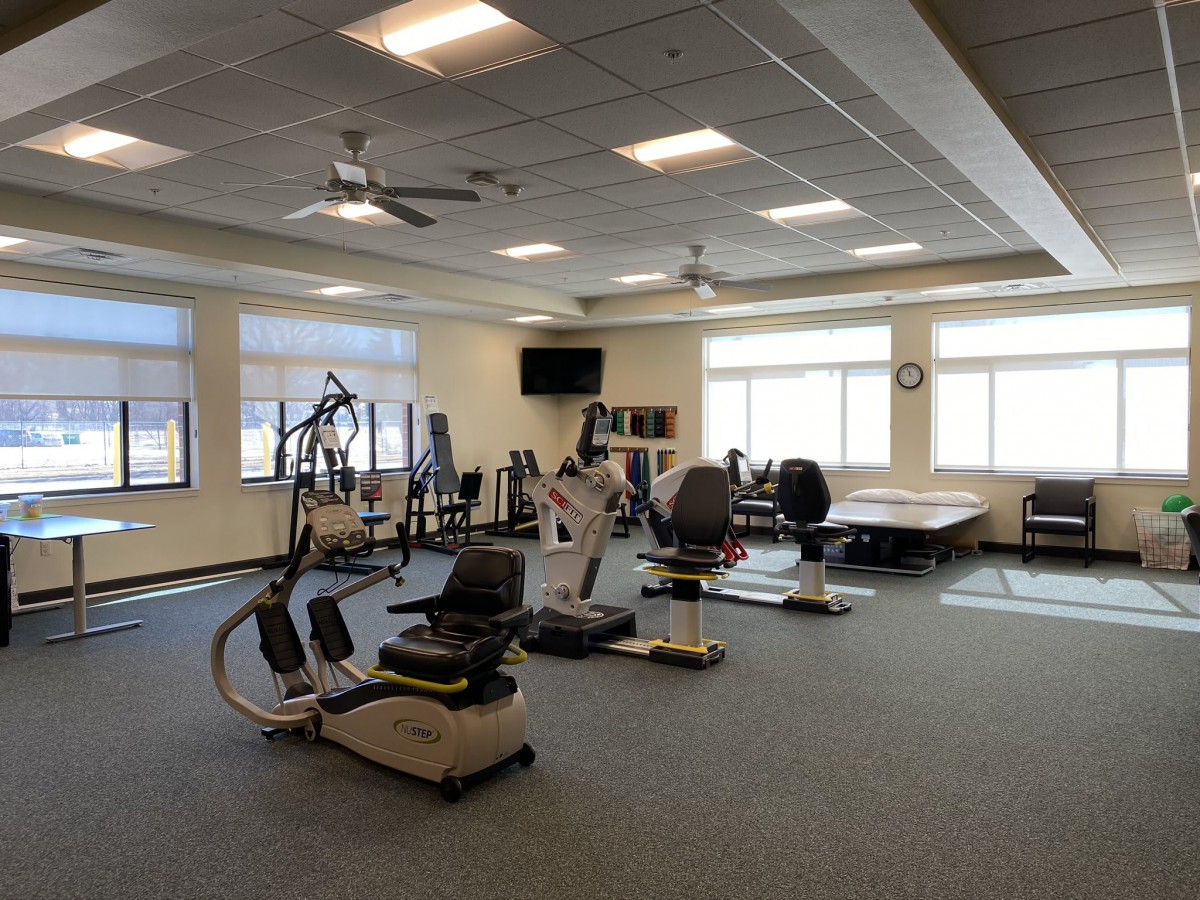 A spacious fitness center with various exercise equipment.