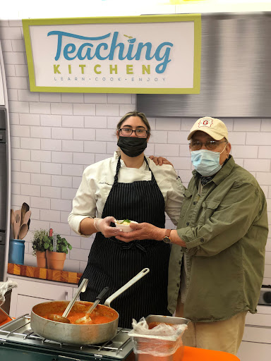 A culinary demonstration in a teaching kitchen, showcasing the art of food preparation.