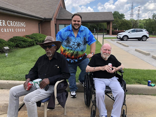 A joyful moment shared among friends outside a community center.