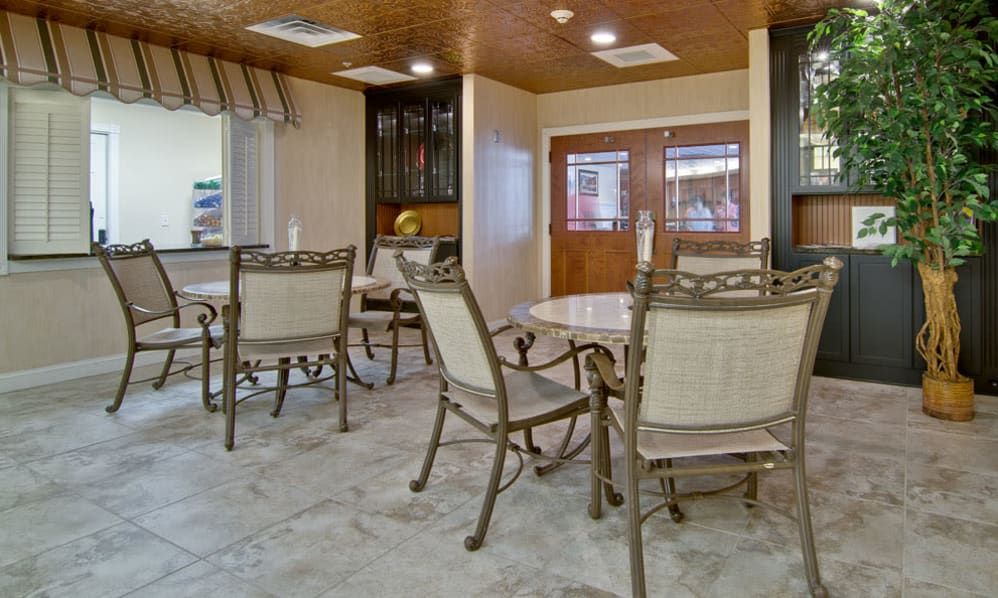 A cozy dining area with tables and chairs arranged neatly.