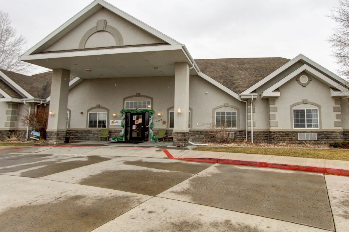A building with a prominent entrance and an overhanging awning on an overcast day.