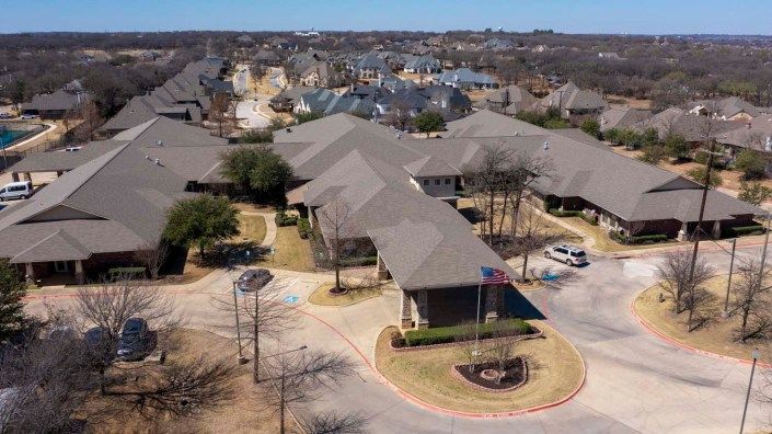 Aerial view of a suburban neighborhood with multiple buildings and roads.