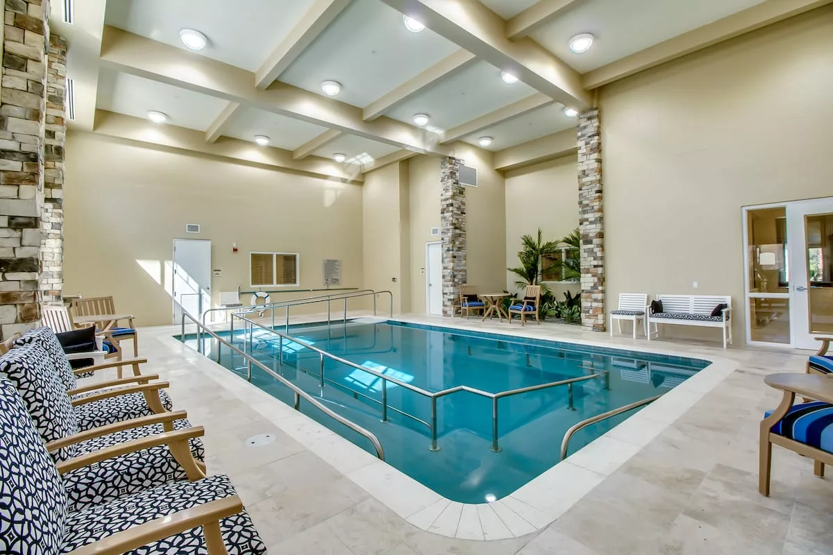 Luxurious indoor swimming pool area with elegant decor and comfortable seating.