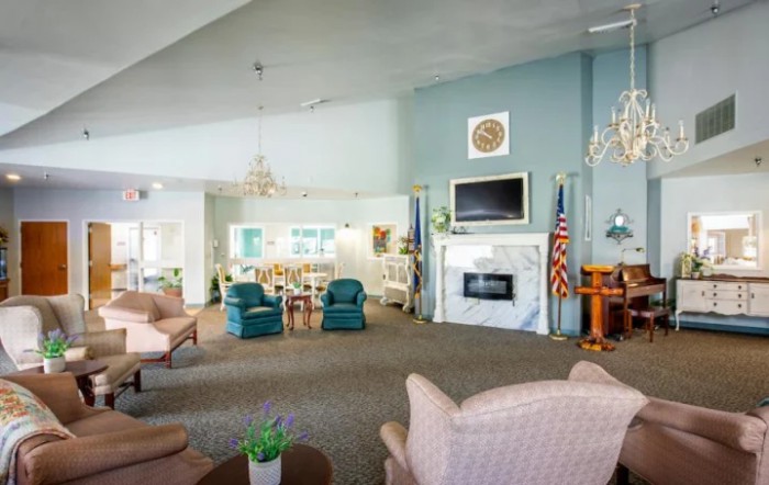 A spacious living area with comfortable seating, fireplace, and television, creating a cozy atmosphere.
