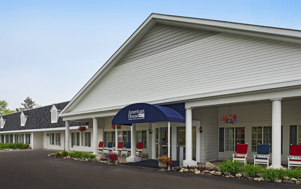 A small inn with a welcoming entrance and a blue awning.