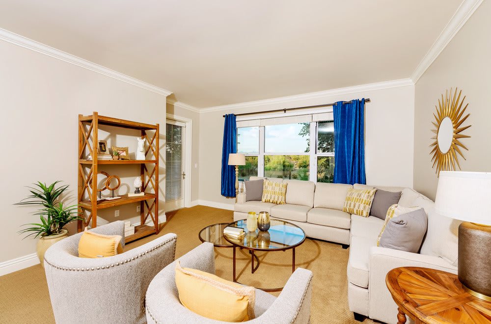 A bright and cozy living room with modern furniture and a large window.