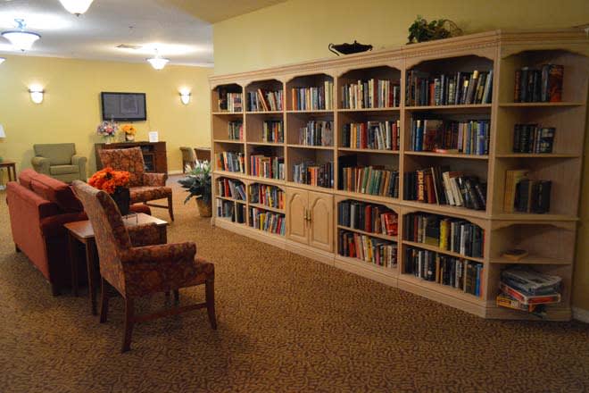 A cozy library with bookshelves and seating area.