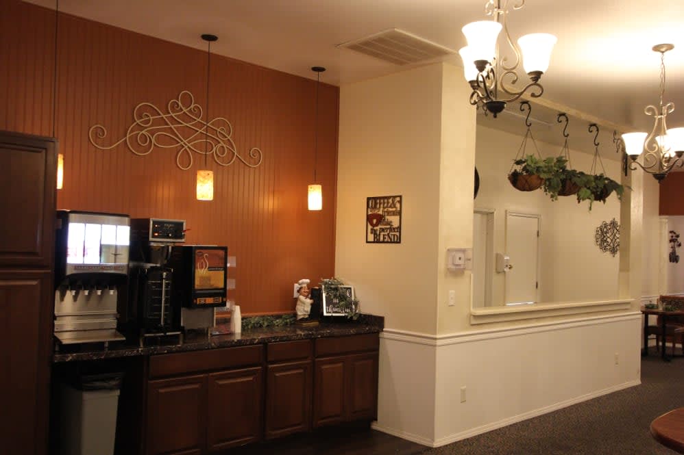 A cozy coffee station with warm lighting and decorative elements.