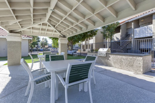 A cozy outdoor seating area with tables and chairs, perfect for gatherings and barbecues.