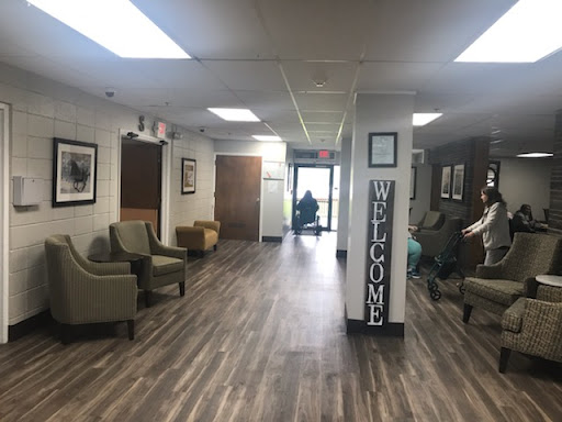 A welcoming waiting area featuring comfortable seating and decorative photographs.