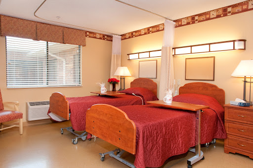 A well-designed hospital room featuring two patient beds, designed for comfort and functionality.