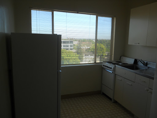 A bright kitchen featuring a window with a view of the outdoors.