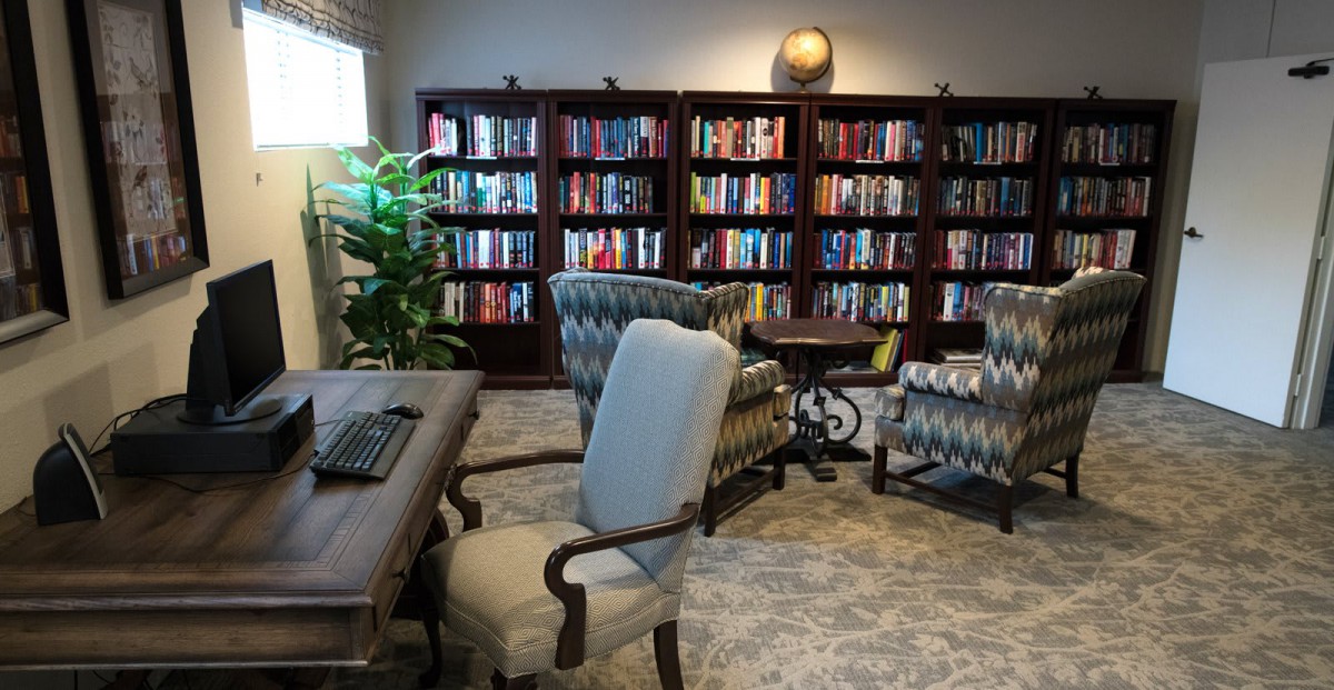 A cozy library space with bookshelves and comfortable seating.