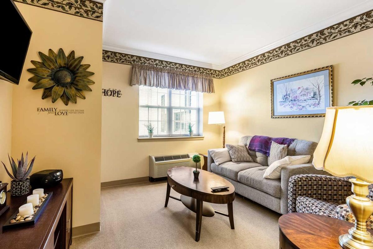 Cozy living room with a sofa, coffee table, and decorative lamp.