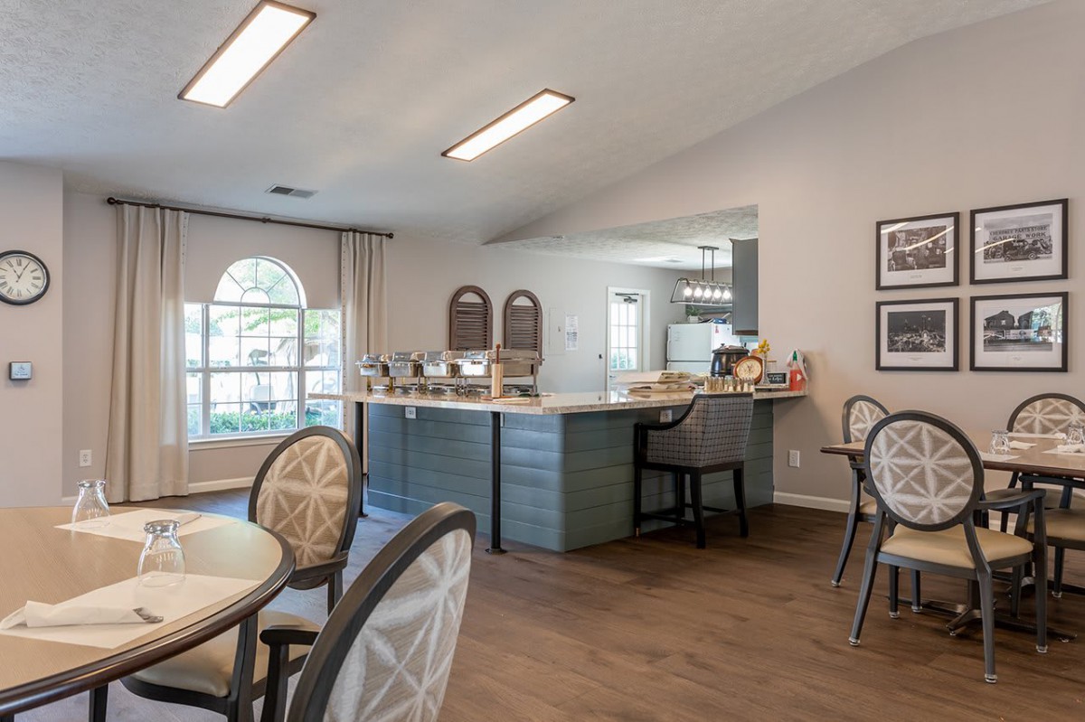 A modern kitchen and dining area with ample natural light and stylish furniture.
