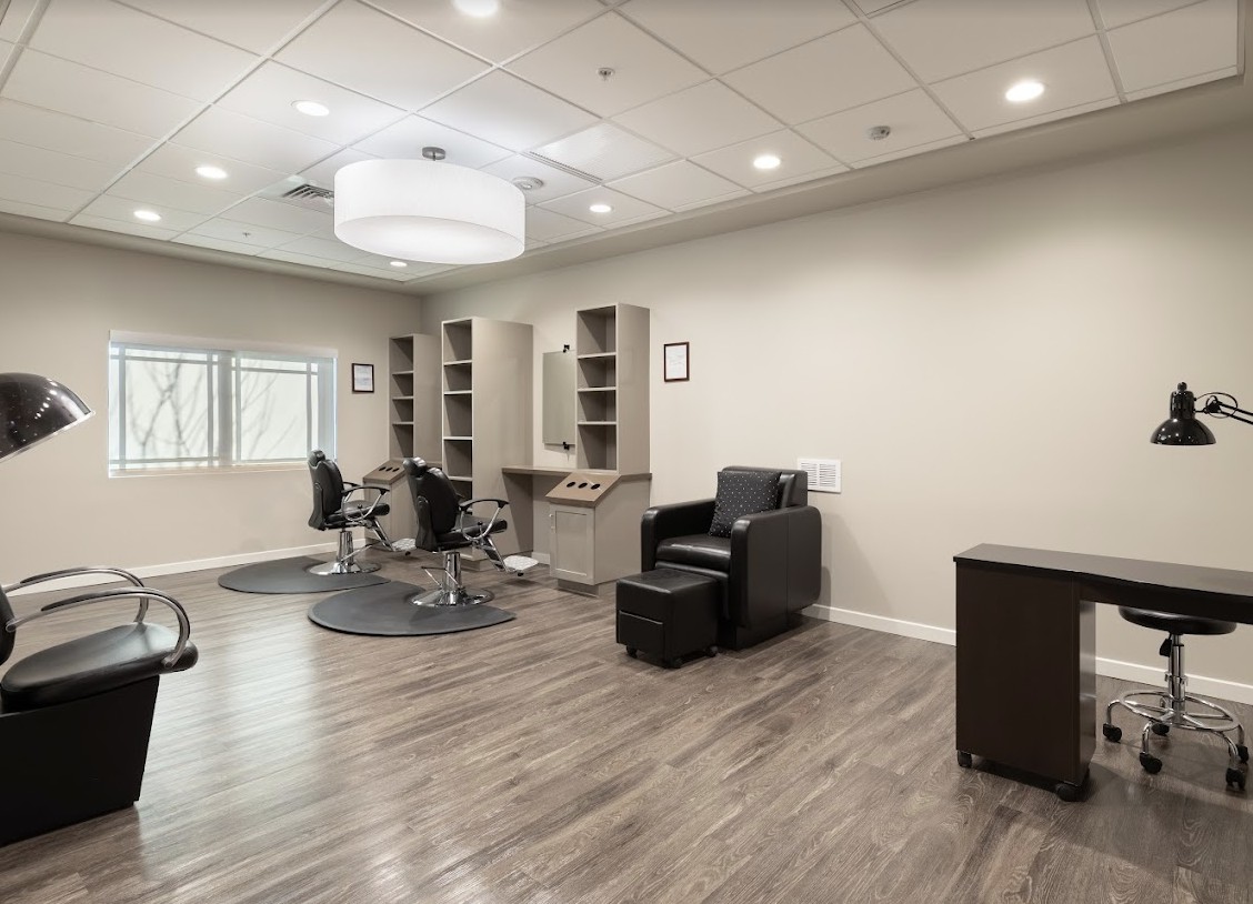 A modern and spacious hair salon with stylish decor and comfortable seating.
