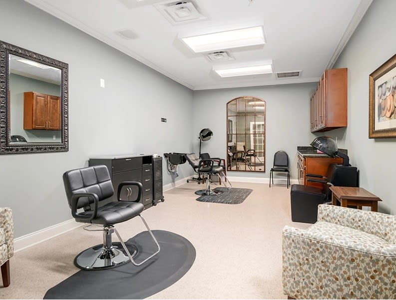 A modern salon interior with styling chairs and mirrors.