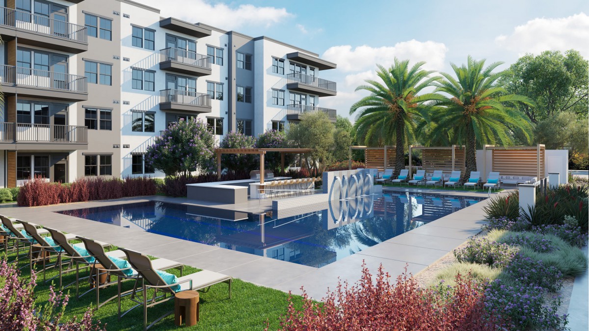 A modern residential complex with a luxurious outdoor swimming pool surrounded by lush landscaping.