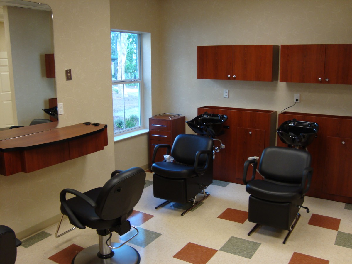 A well-organized barbershop with multiple chairs and hairdressing stations.