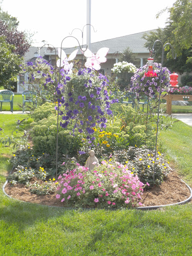 A vibrant garden filled with blooming flowers and decorative butterfly motifs.