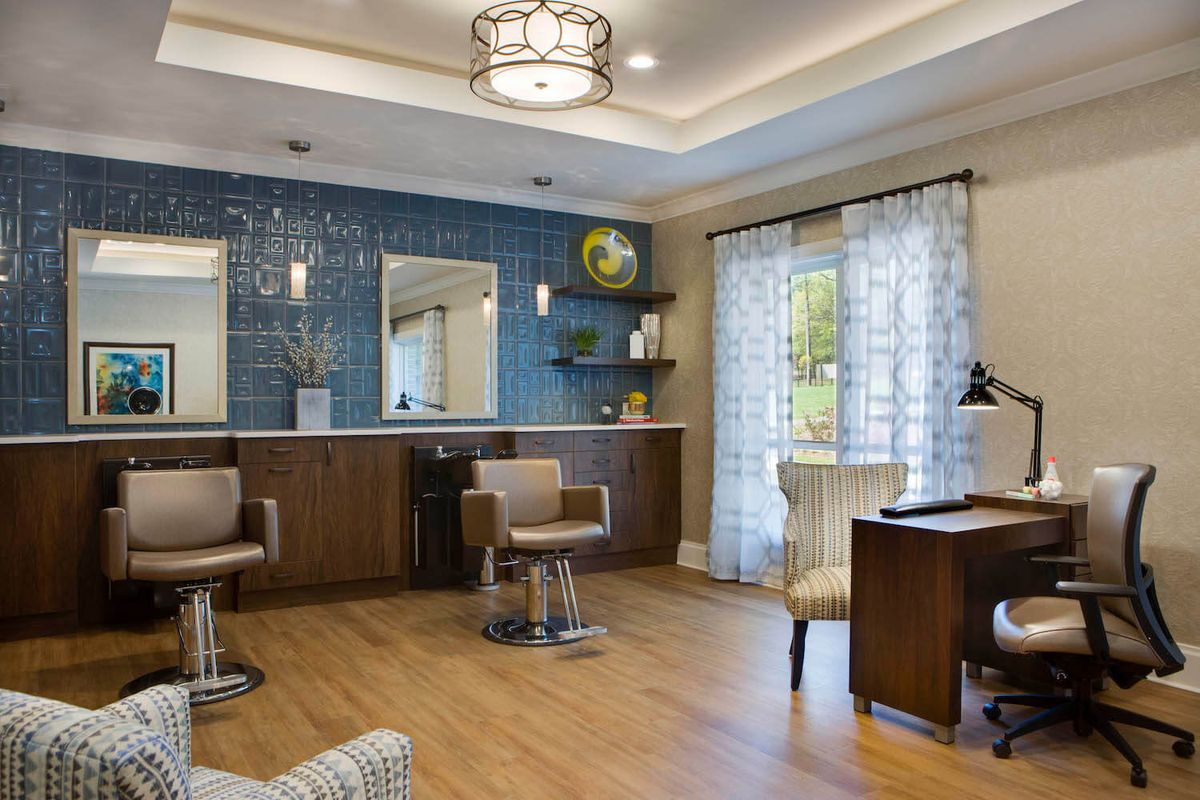 A modern salon interior with stylish furniture and elegant decor.