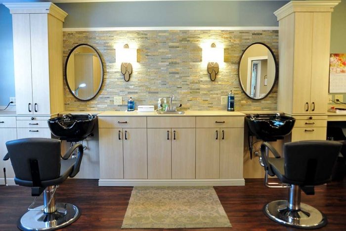 A stylish bathroom vanity with dual mirrors and sconces.