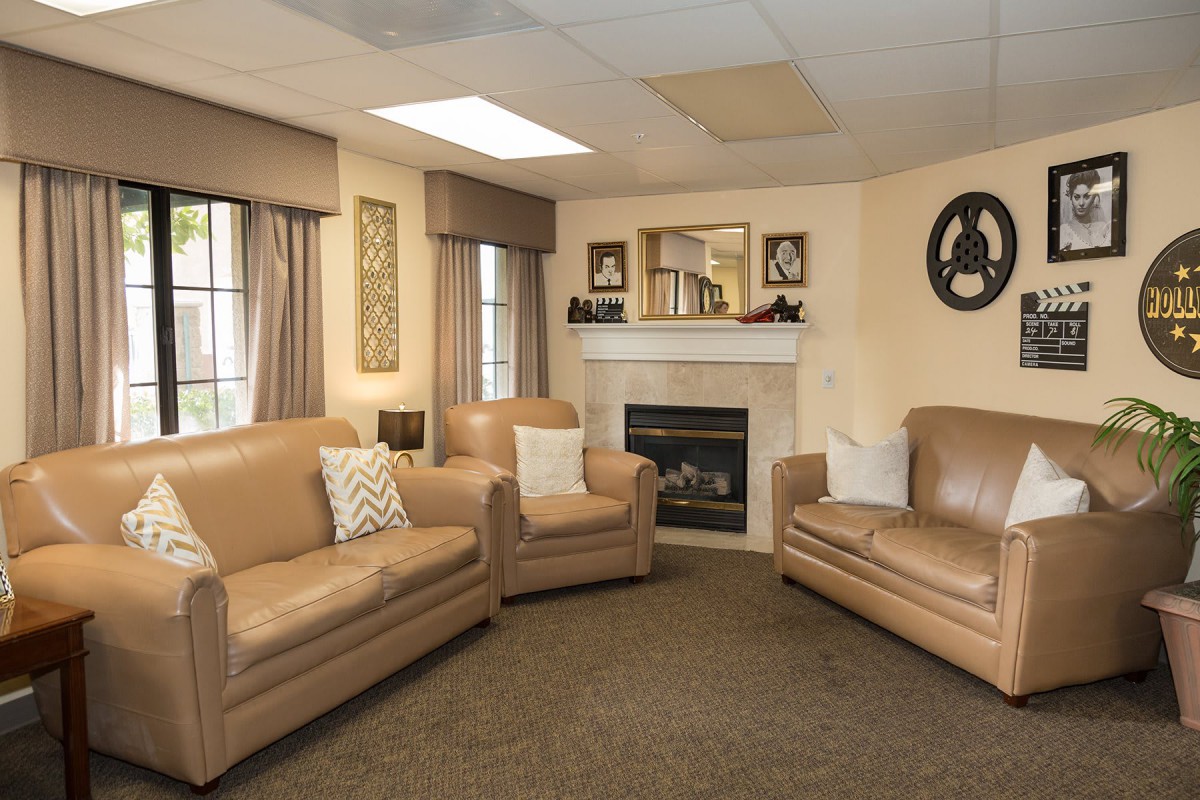 A cozy living room with comfortable seating and a fireplace.