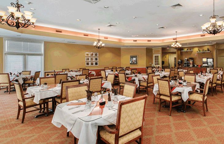 An elegant restaurant interior with neatly arranged tables and chairs.