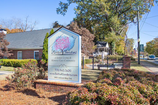 A welcoming sign for a business, surrounded by well-maintained landscaping.