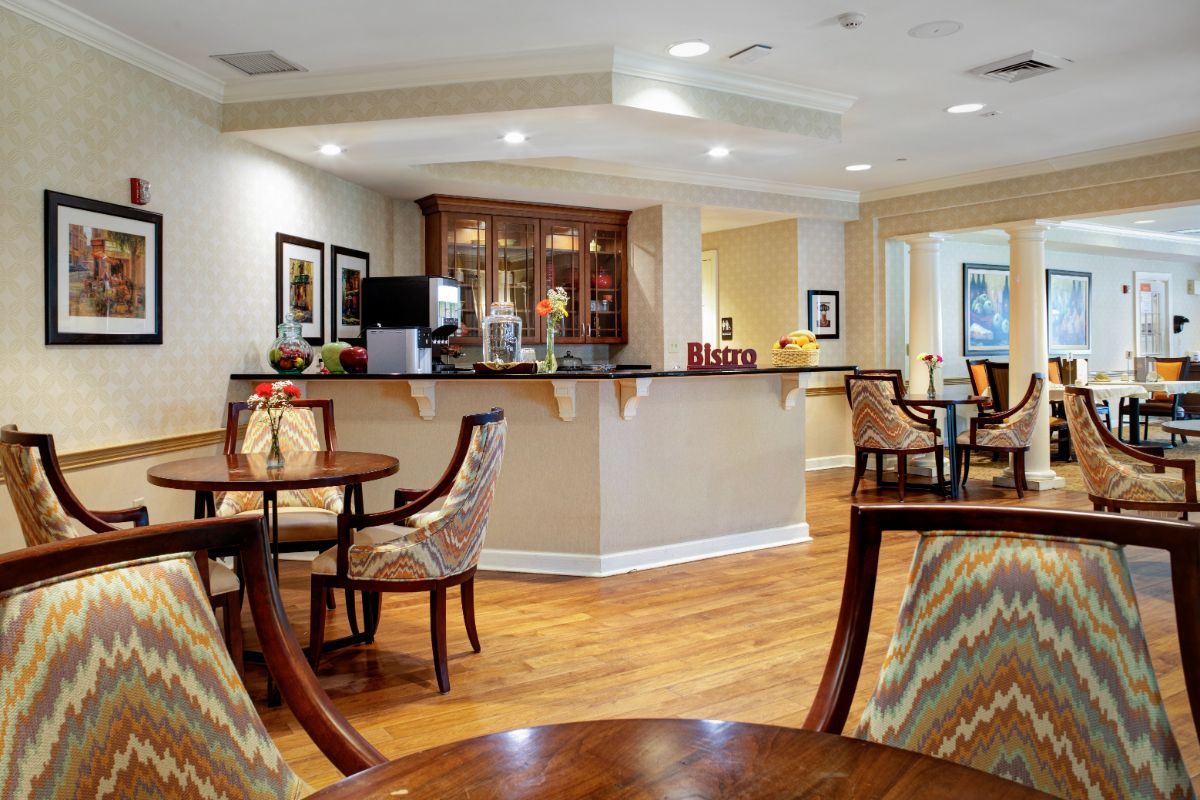 A cozy indoor lounge with elegant seating arrangements and wooden flooring.