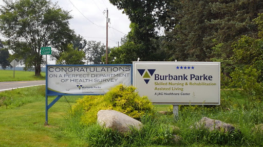 Signage for Burbank Park and a congratulatory banner related to a health department initiative.