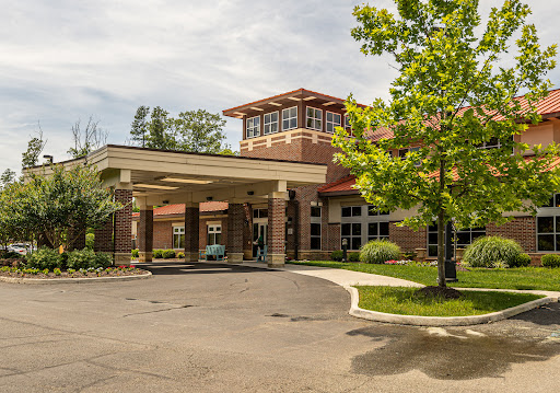 A welcoming entrance to a well-designed building surrounded by greenery.