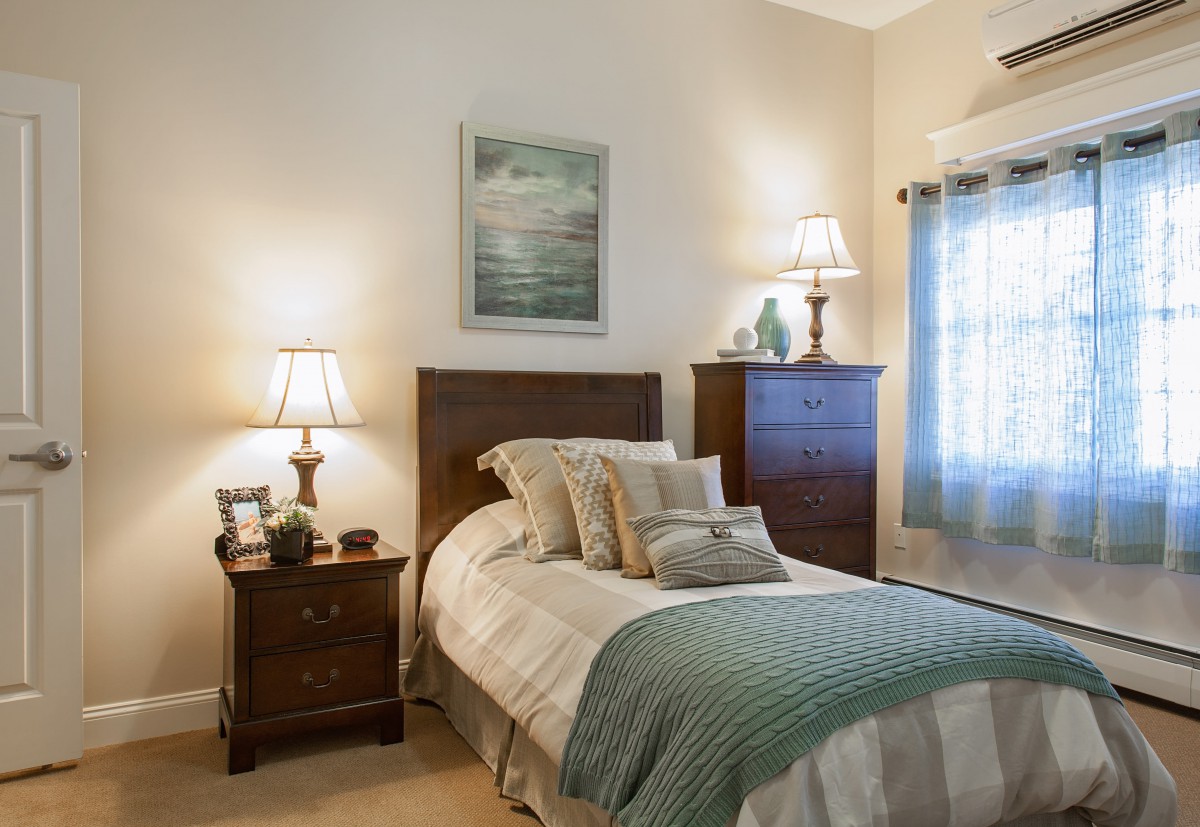 A cozy bedroom with classic furniture and soft lighting.