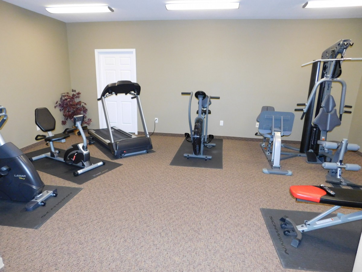 A small gym area with various exercise equipment.