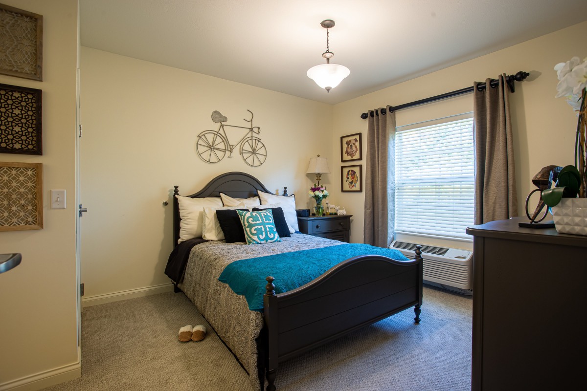A cozy modern bedroom with decorative wall art and elegant furnishings.