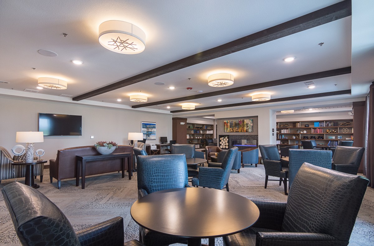 A modern lounge area with comfortable seating, tables, and stylish lighting.