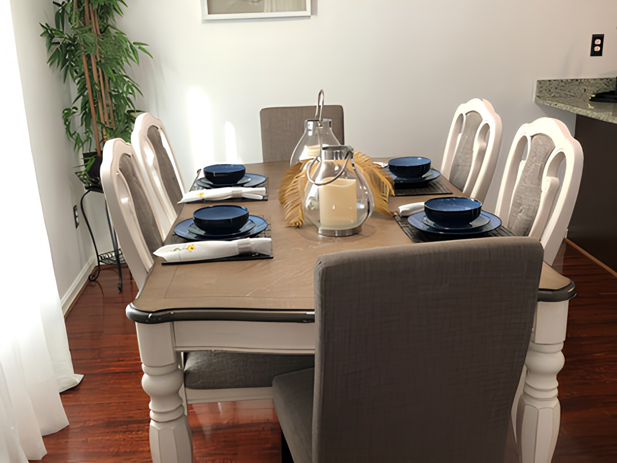 A well-arranged dining table with blue dishes and decorative candles.