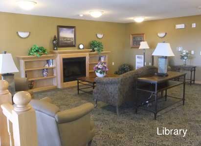 A cozy living room with a fireplace, comfortable seating, and decorative elements.